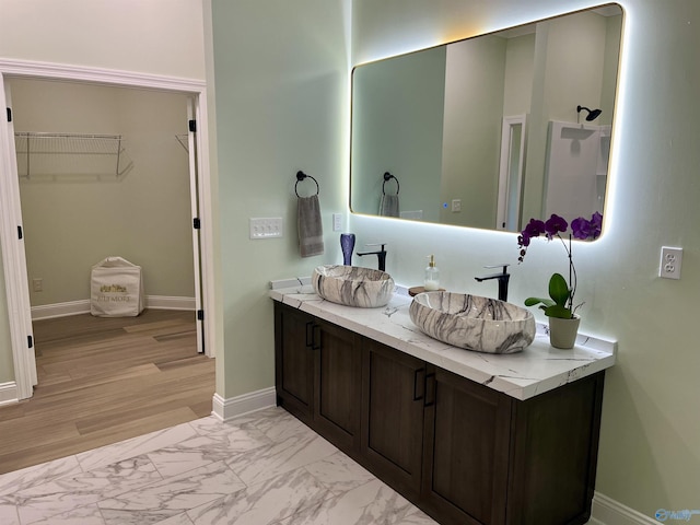 347 Rustic Trce, Grant, AL 35747 - bathroom with double vanity, a walk in closet, baseboards, and marble look tile flooring
