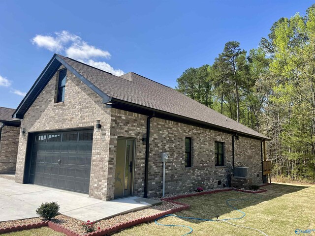 347 Rustic Trce, Grant, AL 35747 - view of side of property featuring brick siding, a lawn, concrete driveway, a shingled roof, and central AC unit