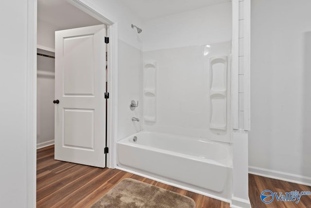 bathroom featuring bathtub / shower combination and hardwood / wood-style flooring