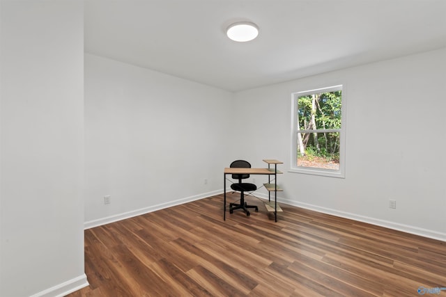 unfurnished office with dark hardwood / wood-style floors