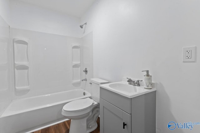 full bathroom with vanity, hardwood / wood-style floors, bathing tub / shower combination, and toilet