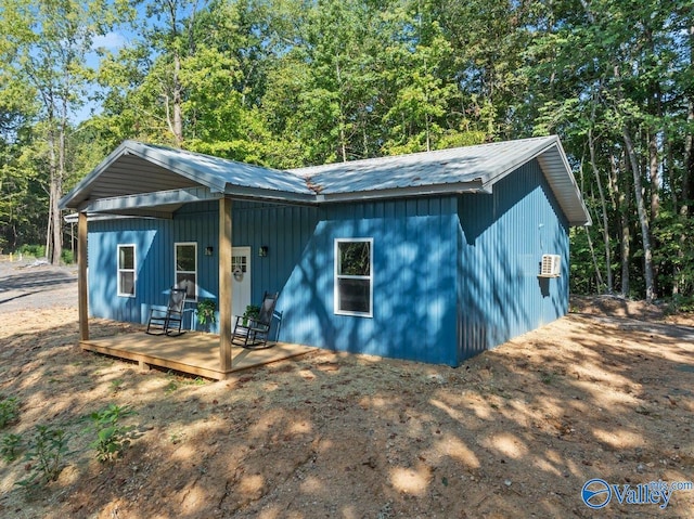 view of outbuilding with an AC wall unit