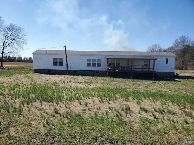 rear view of house featuring a deck and crawl space