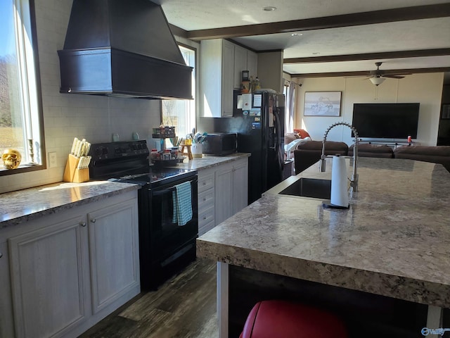 kitchen featuring custom exhaust hood, tasteful backsplash, dark wood-type flooring, beam ceiling, and black appliances
