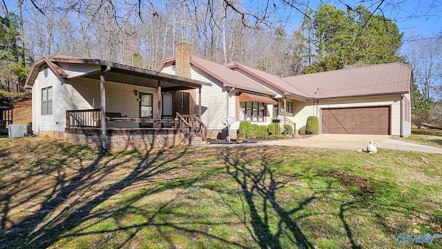 view of front of home featuring a front yard, a garage, a porch, and cooling unit