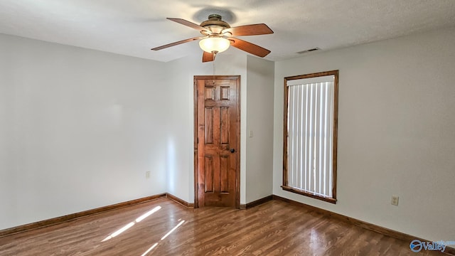 empty room featuring ceiling fan and hardwood / wood-style flooring