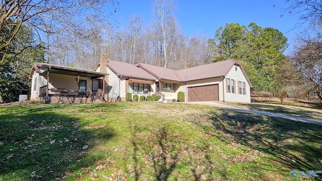 ranch-style home with a front lawn, covered porch, and a garage