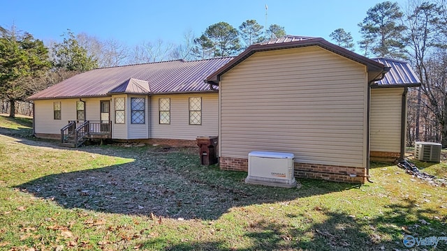 exterior space featuring cooling unit and a lawn