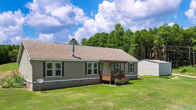 rear view of house with a wooden deck, a lawn, and a shed