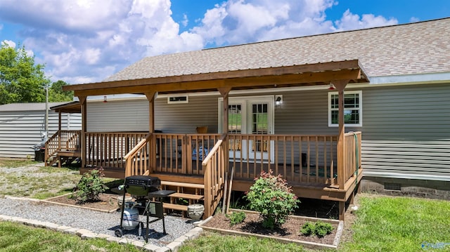 rear view of property featuring a wooden deck