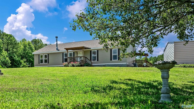 rear view of property featuring a lawn