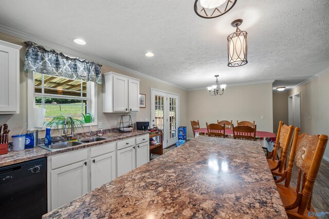 kitchen featuring sink, hanging light fixtures, white cabinetry, a textured ceiling, and dishwasher