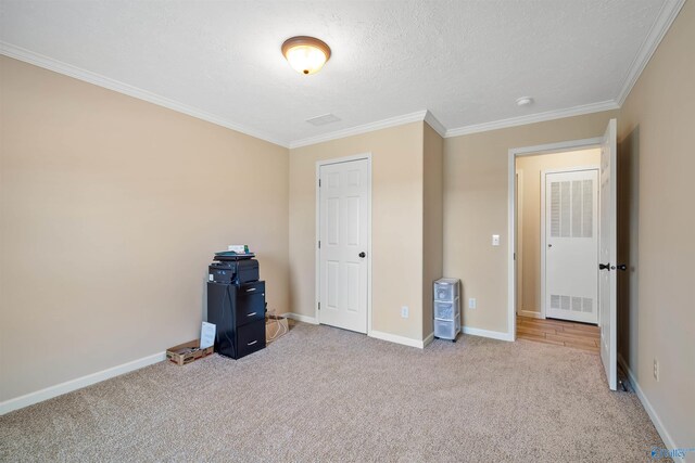 unfurnished bedroom with crown molding, a textured ceiling, and light colored carpet