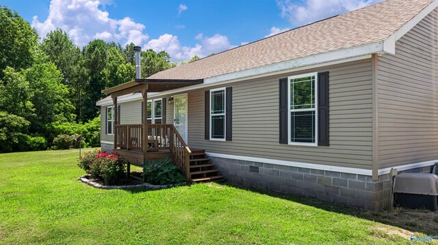 rear view of property featuring central AC unit and a yard