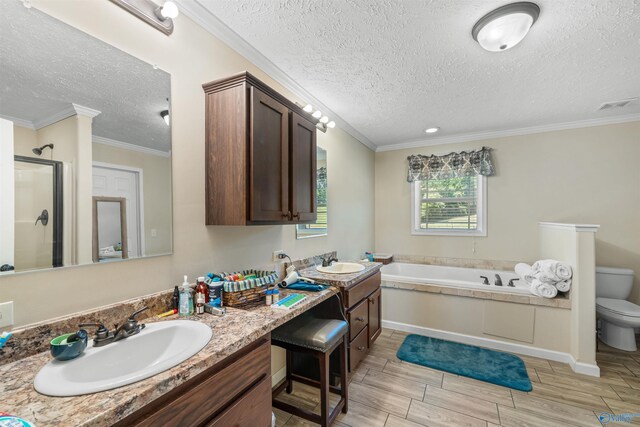 full bathroom featuring vanity, toilet, a textured ceiling, and crown molding