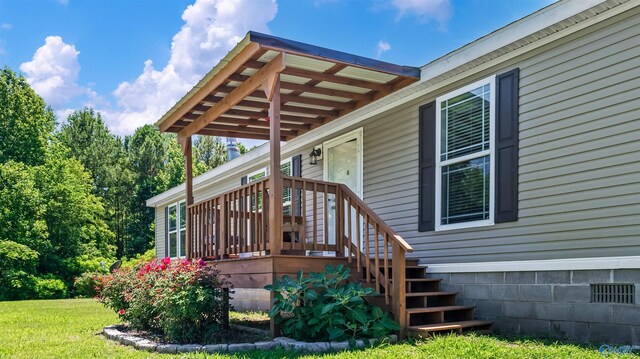 view of exterior entry featuring a yard