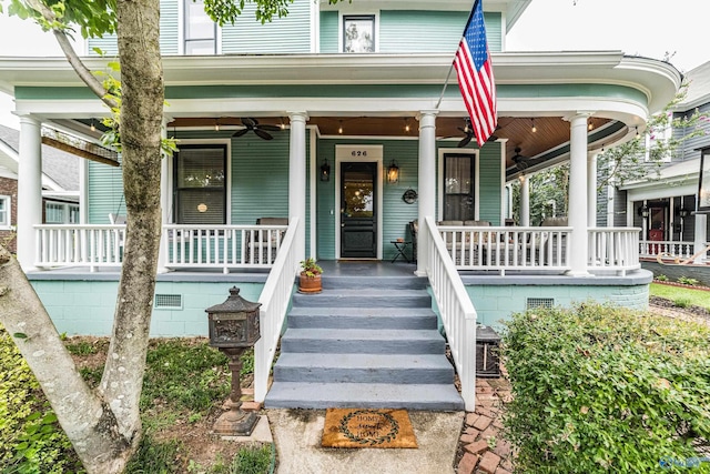 view of exterior entry with ceiling fan and covered porch