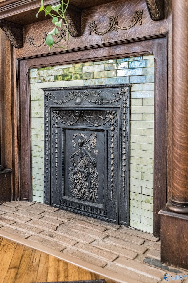 details with wood finished floors and a fireplace with raised hearth