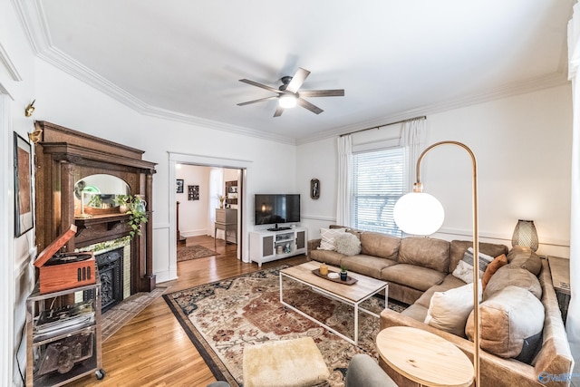 living room with ceiling fan, hardwood / wood-style flooring, and ornamental molding