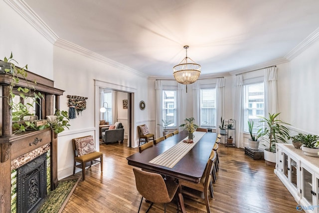 dining area with hardwood / wood-style floors, ornamental molding, and a notable chandelier