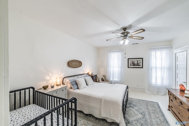 bedroom with visible vents, baseboards, and a ceiling fan