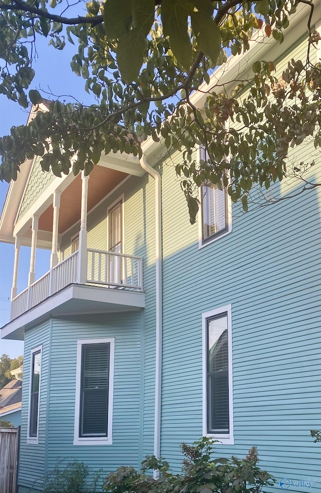 view of side of home featuring a balcony