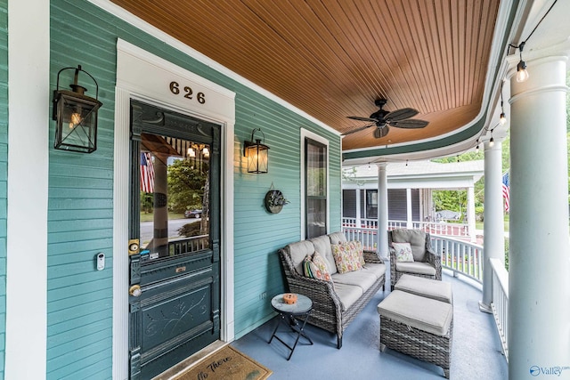 entrance to property featuring covered porch and a ceiling fan