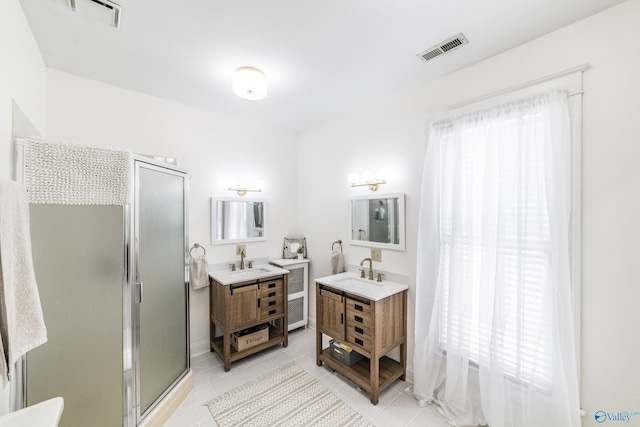 bathroom featuring dual vanity, tile patterned flooring, and a shower with shower door