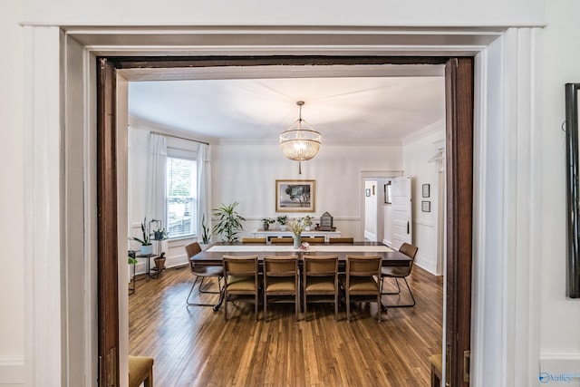 dining space with dark wood finished floors and crown molding