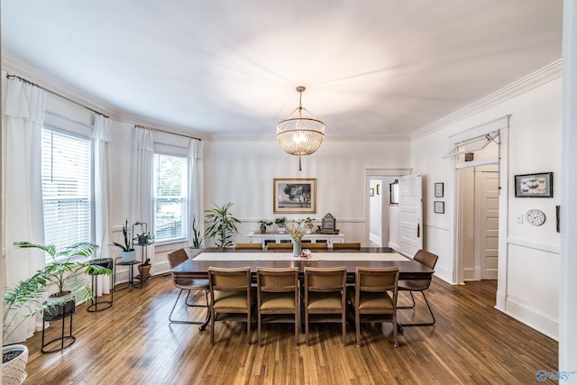 dining area featuring dark wood finished floors, an inviting chandelier, and ornamental molding