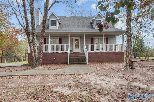 cape cod house featuring covered porch