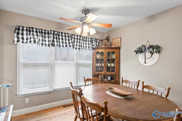 dining room with a healthy amount of sunlight, light wood-type flooring, and ceiling fan