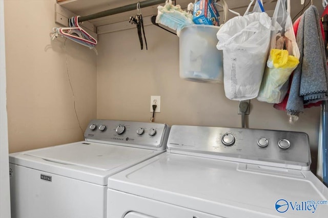 clothes washing area featuring separate washer and dryer