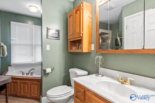 bathroom featuring vanity, toilet, tile patterned flooring, and a bathing tub