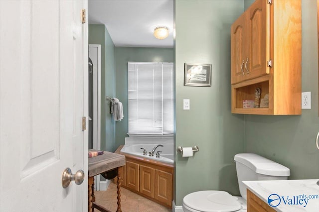 bathroom featuring vanity, tile patterned flooring, toilet, and a bathing tub