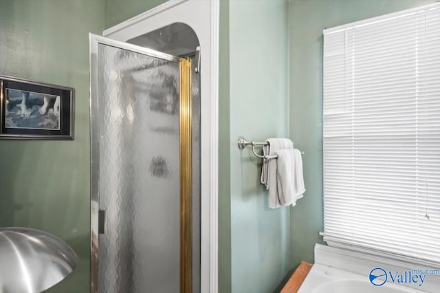 bathroom with a shower with door