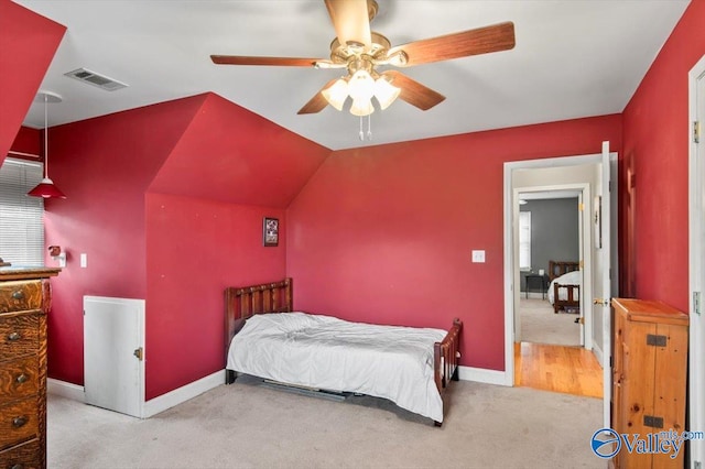 carpeted bedroom featuring vaulted ceiling and ceiling fan