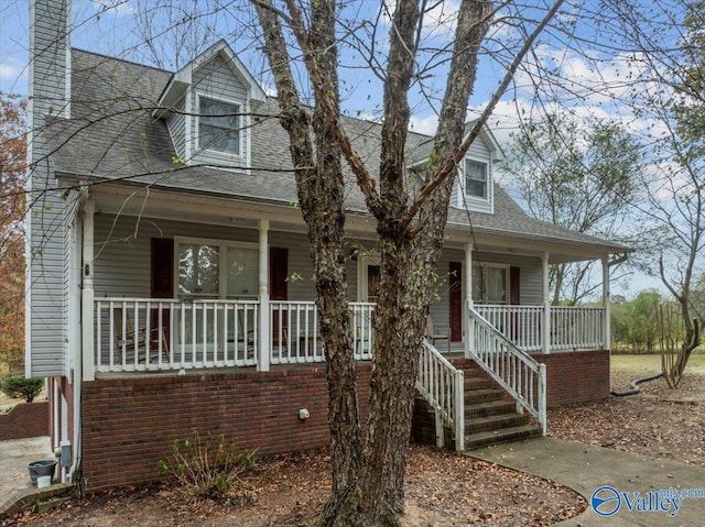 new england style home with a porch