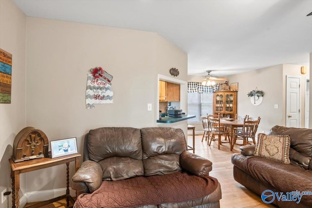 living room featuring light hardwood / wood-style floors and ceiling fan