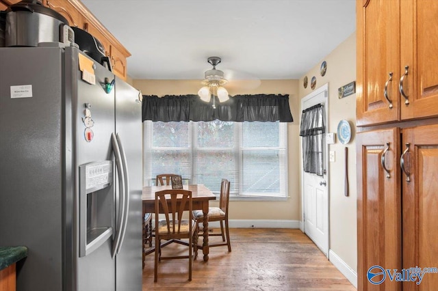 kitchen featuring hardwood / wood-style floors, stainless steel fridge, and ceiling fan