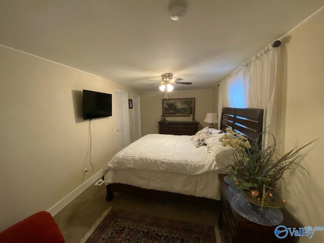 carpeted bedroom with baseboards and a ceiling fan