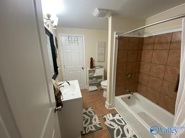 bathroom with tile patterned flooring, toilet, visible vents, vanity, and washtub / shower combination