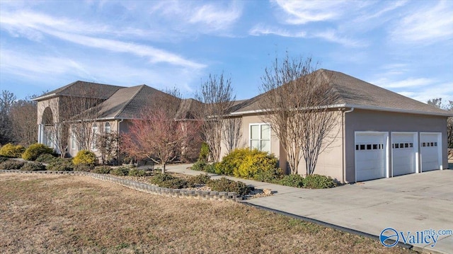 view of front of property featuring a garage and a front lawn