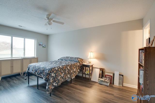 bedroom with a textured ceiling, dark hardwood / wood-style flooring, and ceiling fan