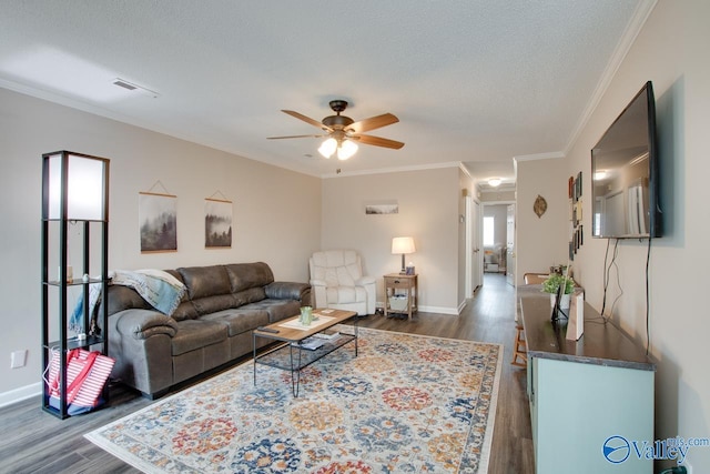 living room featuring a textured ceiling, ceiling fan, dark hardwood / wood-style flooring, and crown molding