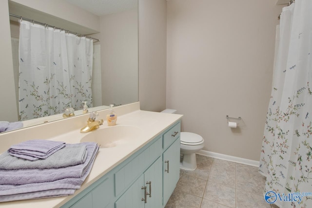 bathroom featuring tile patterned flooring, vanity, a textured ceiling, and toilet