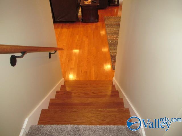 staircase with hardwood / wood-style flooring