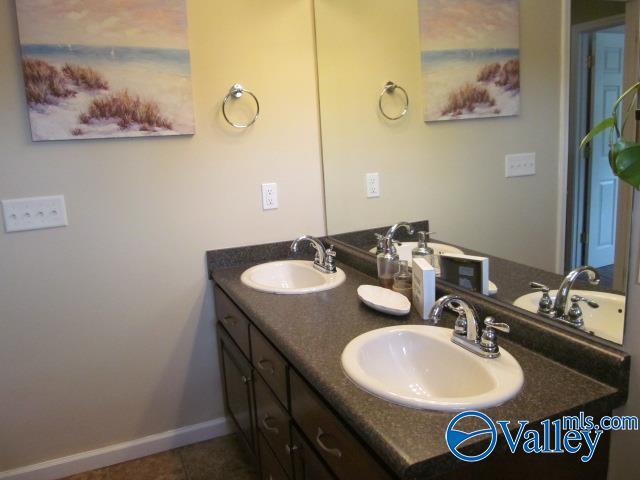 bathroom with tile patterned flooring and vanity