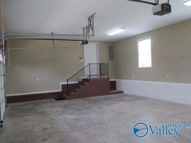 garage featuring electric panel and a garage door opener