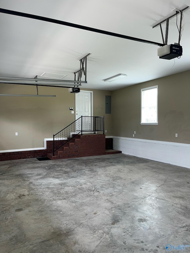 garage with a garage door opener and electric panel